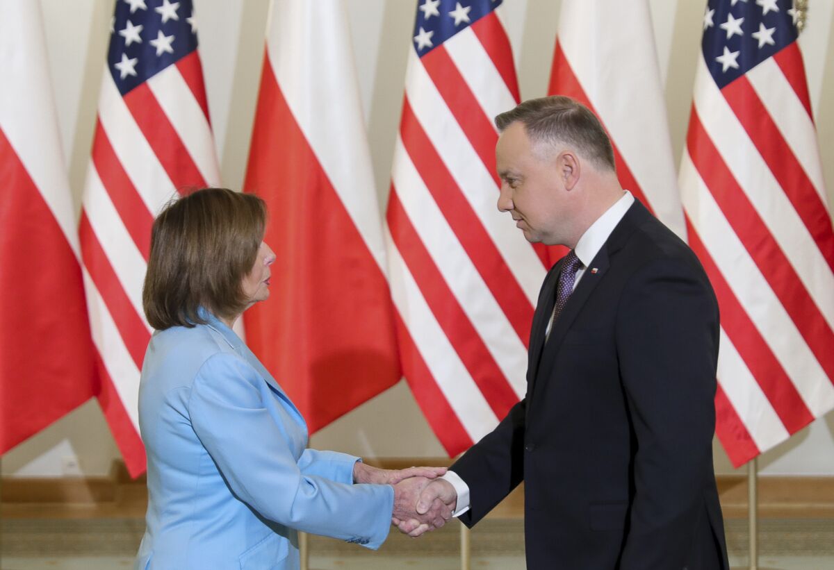 Nancy Pelosi shakes hands with Andrzej Duda