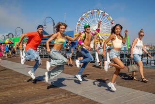 SANTA MONICA, CA-AUGUST 16, 2023: left to right-Justin Corbo, 25, Vanesa Seco, 27, Kento Moriguchi, 24, and Shivani Shah, 24, perform a shuffle dance routine on the Santa Monica Pier in Santa Monica. There has been a rise in L.A. dancers shuffling in iconic L.A. spots to make videos that then twirl around social media. (Mel Melcon / Los Angeles Times)