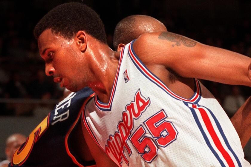 Clippers forward Lorenzen Wright scrambles for the ball during a game against the Golden State Warriors in 1999. Wright was a first-round pick for the Clippers in 1996.