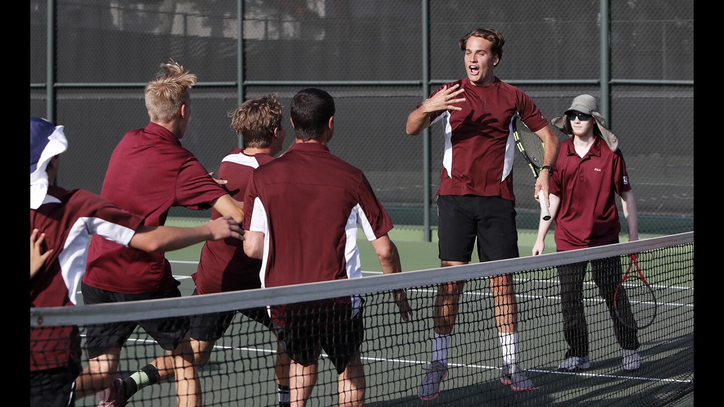 Laguna Beach High boys' tennis team rush the court after No. 3 doubles players Francis Pillsbury, second from right, and Kyle Herkins, far right, clenched the championship against Redlands East Valley in the CIF Southern Section Division 4 title match at The Claremont Club on Friday, May 18.