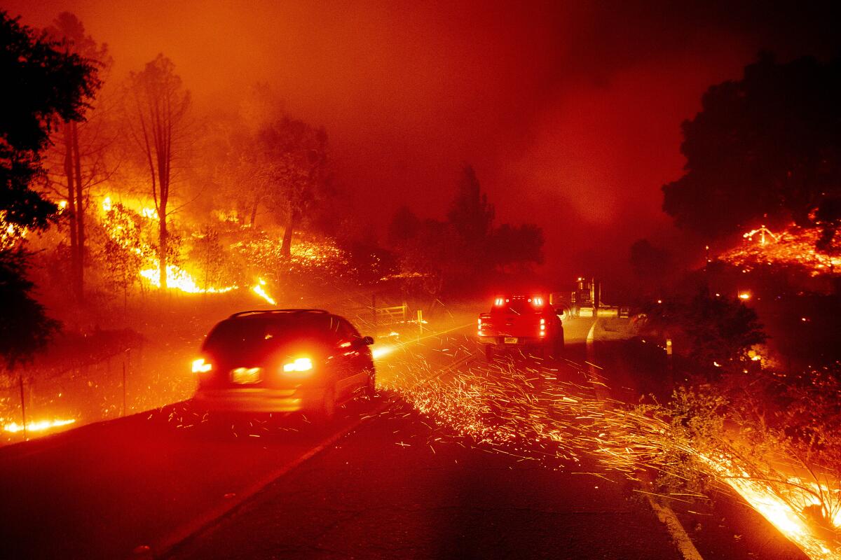 Embers fly across a roadway as the Kincade Fire burns through Sonoma County on Thursday.