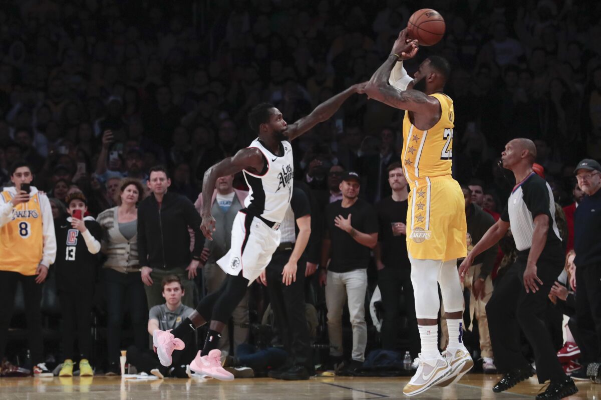 Clippers guard Patrick Beverley causes Lakers forward LeBron James to lose control of the ball with 3 1/2 seconds to play.