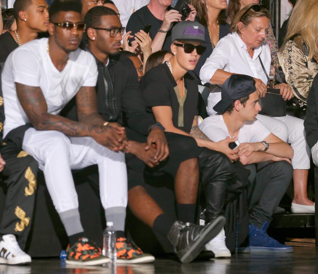 NBA players Iman Shumpert, left, and John Wall, center, and singer Justin Bieber attend the Y-3 spring/summer 2014 runway show during Mercedes-Benz Fashion Week.