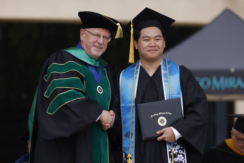 Allen Kuo at commencement 2023 with Miramar College President Wes Lundburg.