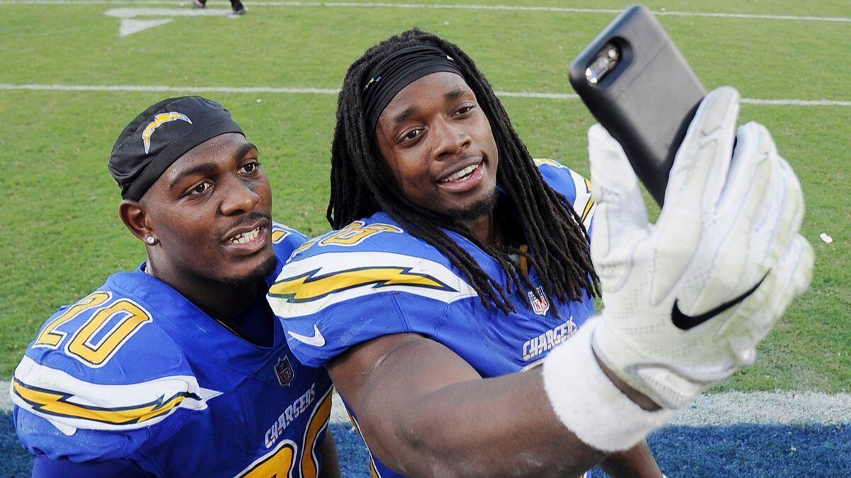 Chargers cornerback Desmond King, left, poses for a selfie with running back Melvin Gordon after the Chargers defeated the Cleveland Browns on Dec. 3.