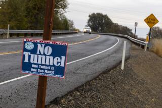 Hood, CA - December 06: A sign of opposition to The Delta Conveyance Project along a levee road near the Sacramento River on Wednesday, Dec. 6, 2023 in Hood, CA. One of two proposed intakes for the Delta tunnel is nearby the small town. (Brian van der Brug / Los Angeles Times)