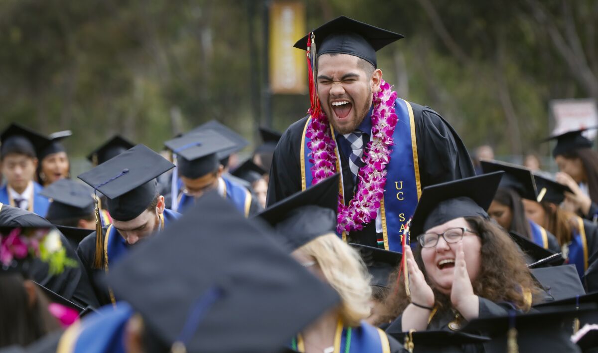 UC San Diego ethnic-studies major David Rodriguez exults during a commencement ceremony in 2019. 