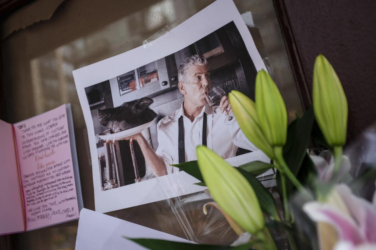 Notes, photographs and flowers are left in memory of Anthony Bourdain at the closed location of Brasserie Les Halles, where Bourdain used to work as the executive chef.