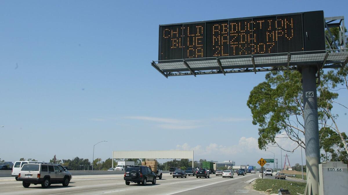 An Amber Alert freeway sign asks motorists to be on the lookout for a vehicle.