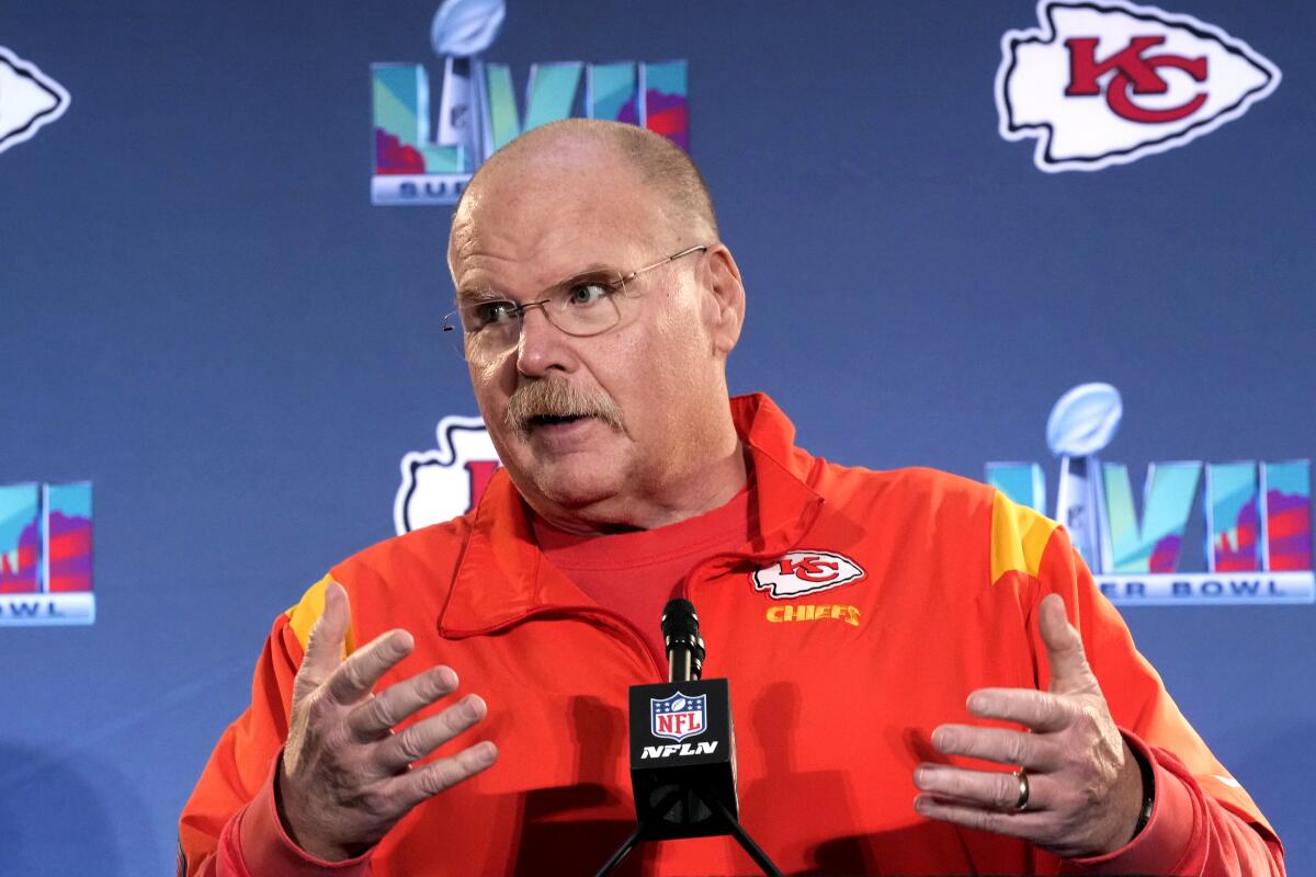 Kansas City Chiefs coach Andy Reid holds his hands out and speaks while looking to the side