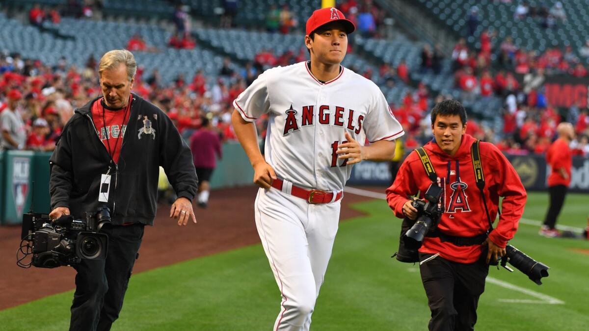 Shohei Ohtani of the Angels runs on the field to accept his American League rookie of the year award before the game against the Toronto Blue Jays at Angel Stadium on April 30, 2019.