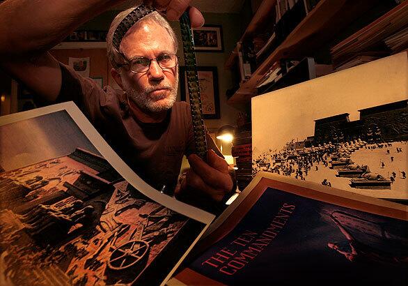 Peter Brosnan looks over materials he's gathered over the years to film a documentary about Cecil B. DeMille's buried movie set from the 1923 version of "The Ten Commandments."