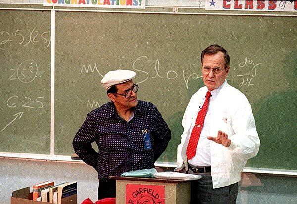 Vice President George H.W. Bush answers questions from students during a visit to Garfield High School in East Los Angeles on May 5, 1988. Bush is wearing a jacket presented to him by Escalante.