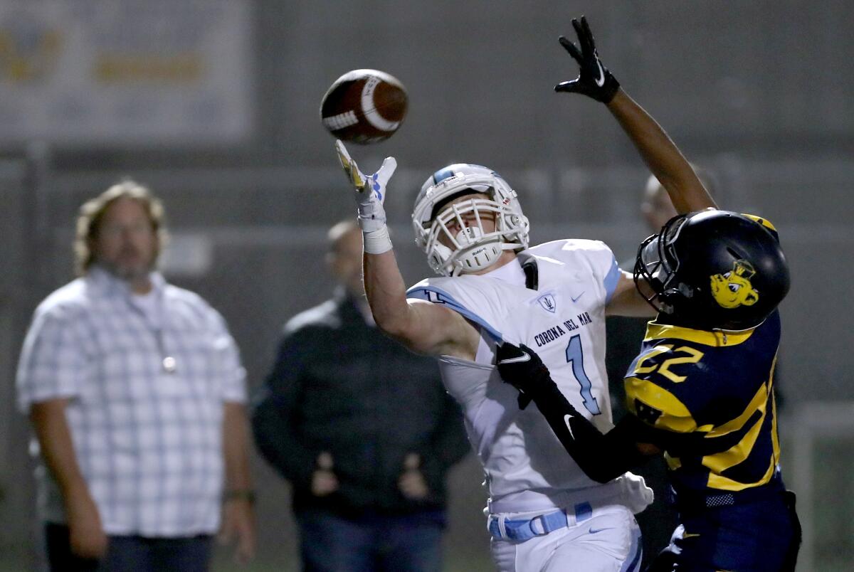 Corona del Mar's Max Lane can't grab the ball as he is held by Khalil Williams in the end zone.