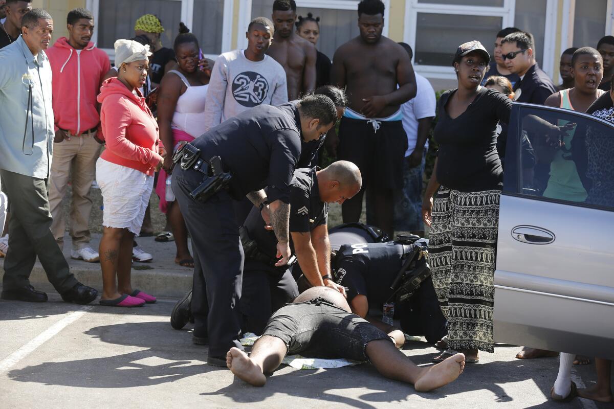 LAPD officers try to revive a resident of Nickerson Gardens.