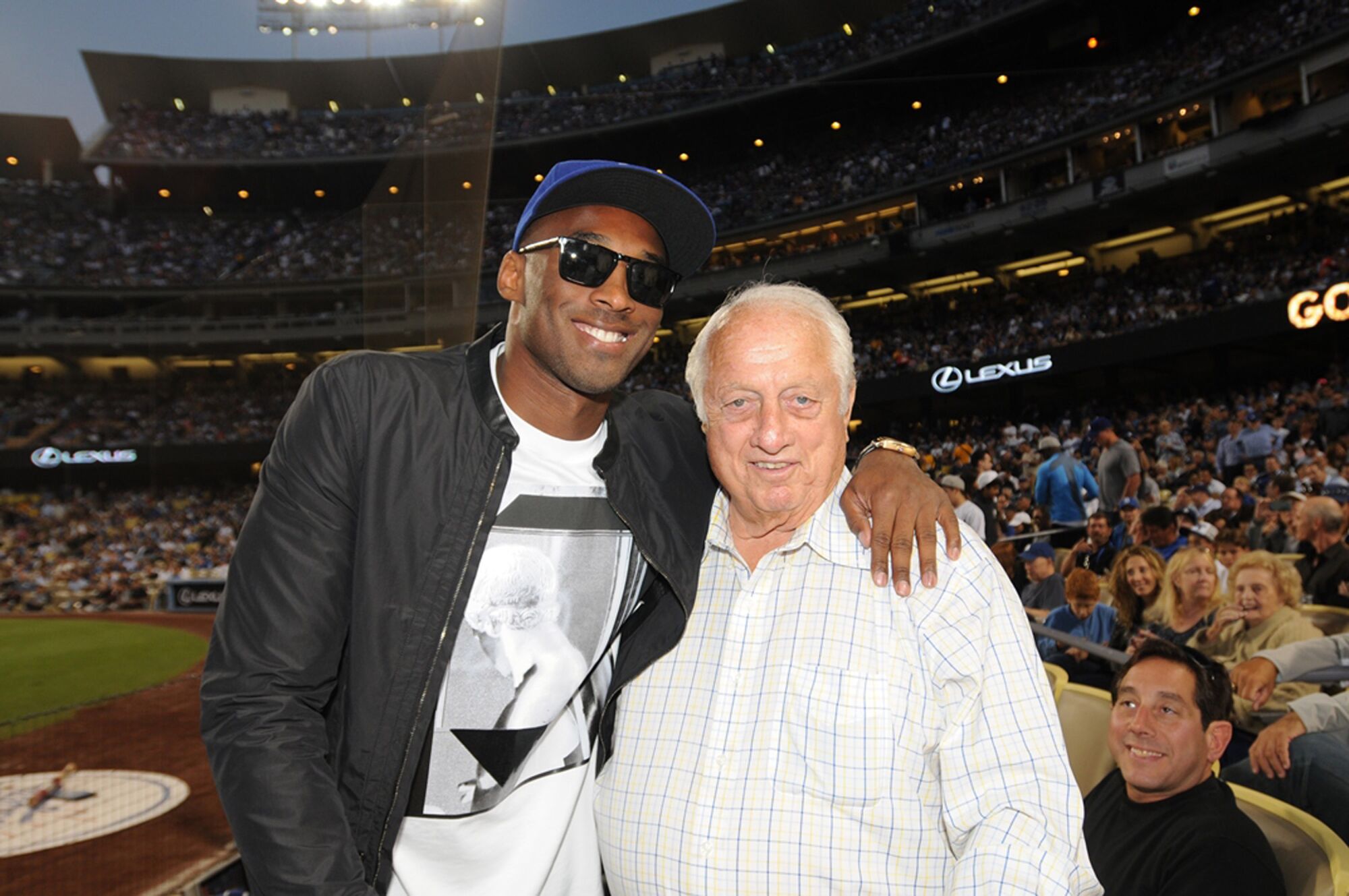 In 2013, Lakers star Kobe Bryant, left, joins Tommy Lasorda at a game between the Dodgers and the New York Yankees