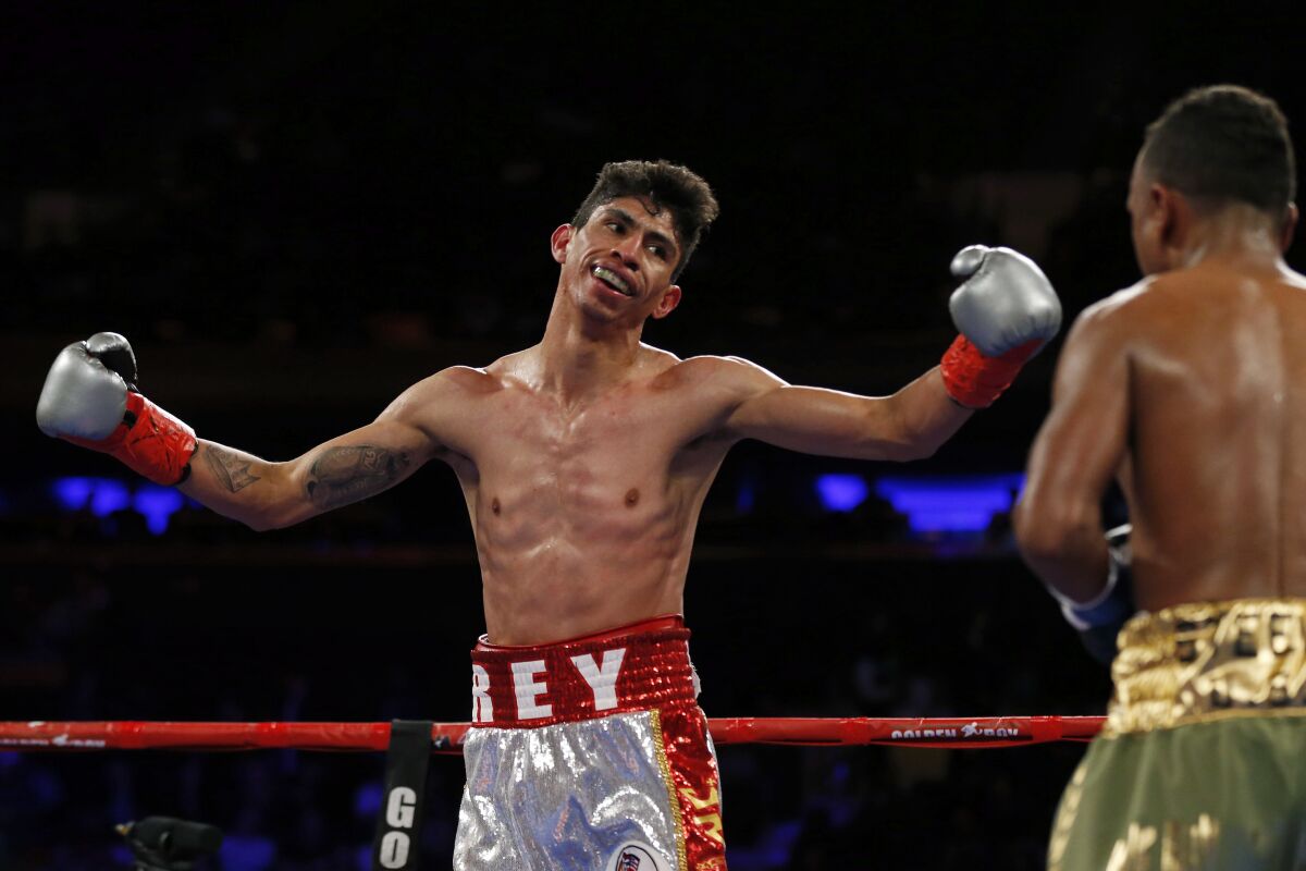 Rey Vargas reacts during the third round of a WBC junior featherweight title boxing match against Oscar Negrete