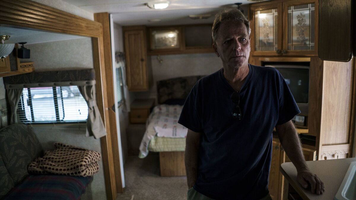 Raymond Taylor looks around the temporary trailer where he and his wife Linda have lived for more than year after the Erskine fire.