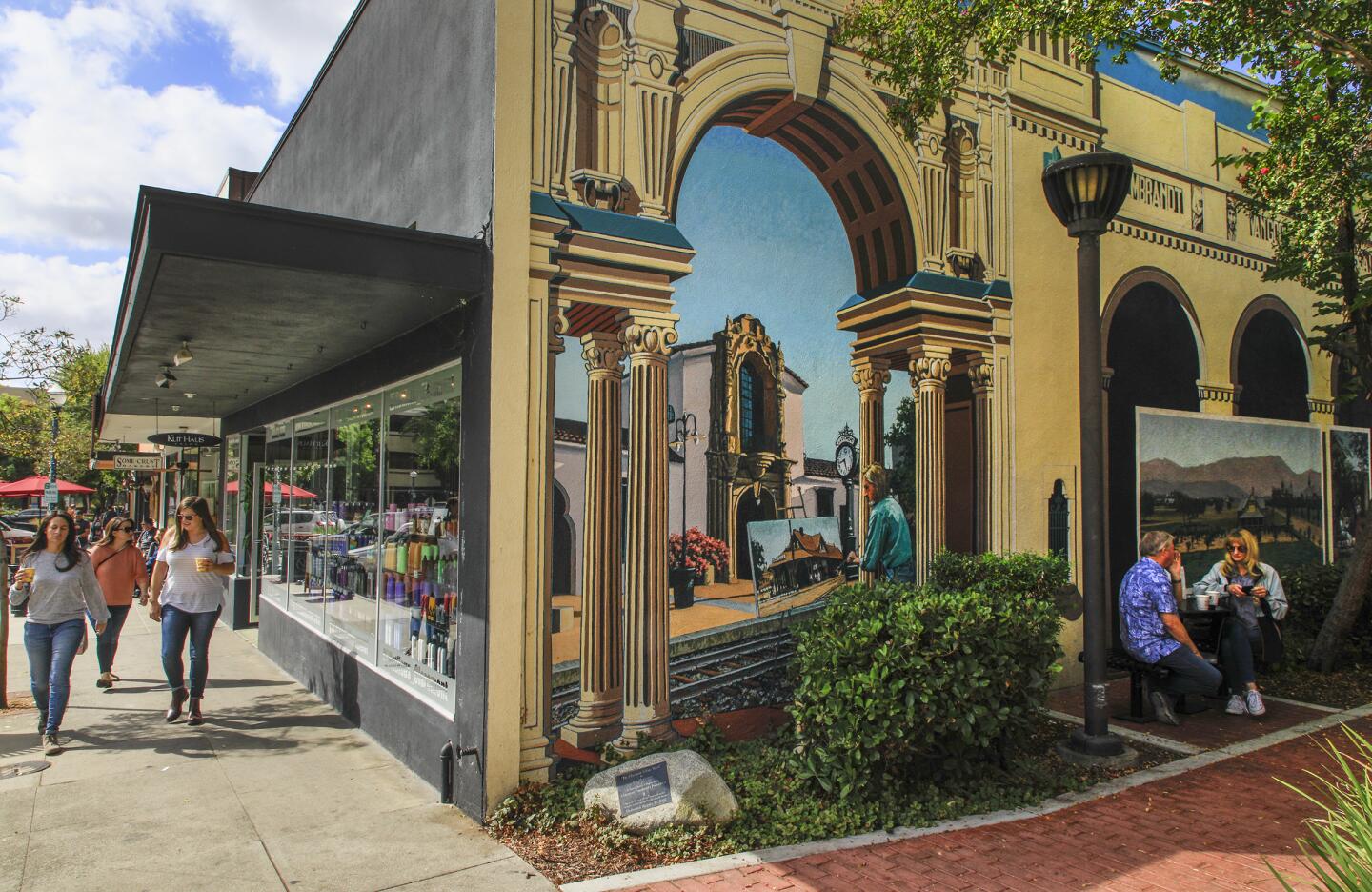 Artist Art Mortimer created a giant mural of historic street scenes in Claremont Village on the wall of the paseo at 123 Yale in the city of Claremont, 30 miles east of Los Angeles at the base of the San Gabriel Mountains. The unique collection of old, restored buildings house record stores, antique shops, cafes and a bakery.