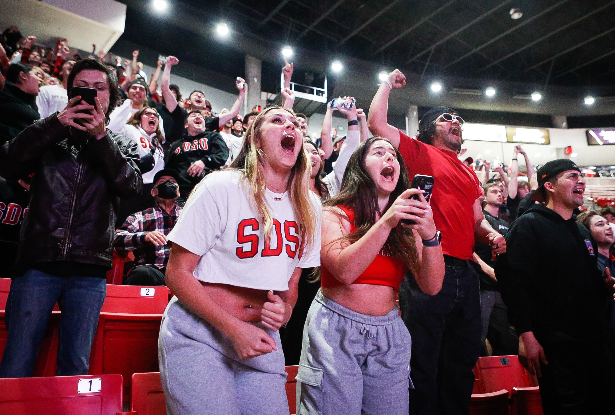 Davis and Eden Molay celebrate after the Aztecs' beat Alabama at a watch party