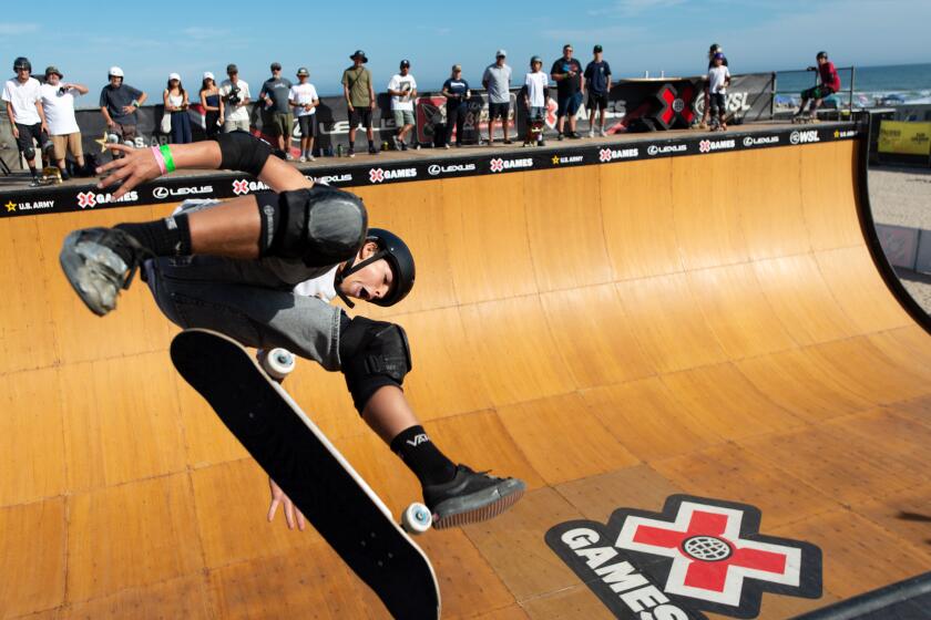 Skaters demonstrate their skills on a vert ramp built on the sand just south of Huntington Beach Pier Sunday, Aug. 3.