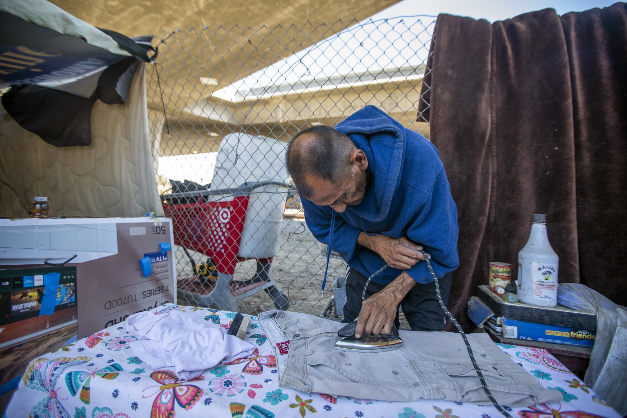 A man ironing clothes