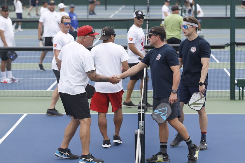 Teams from several Southern California agencies prepare to compete, during first annual, First Responders Pickleball Tournament at the Tennis and Pickleball Club at Newport Beach on Wednesday.