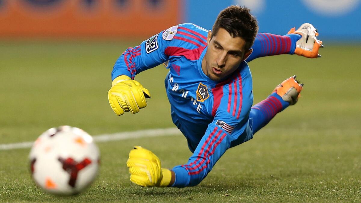 Galaxy goalkeeper Jaime Penedo dives toward a shot that drifts wide of the goal during a match against Club Tijuana at StubHub Center on March 12, 2014.