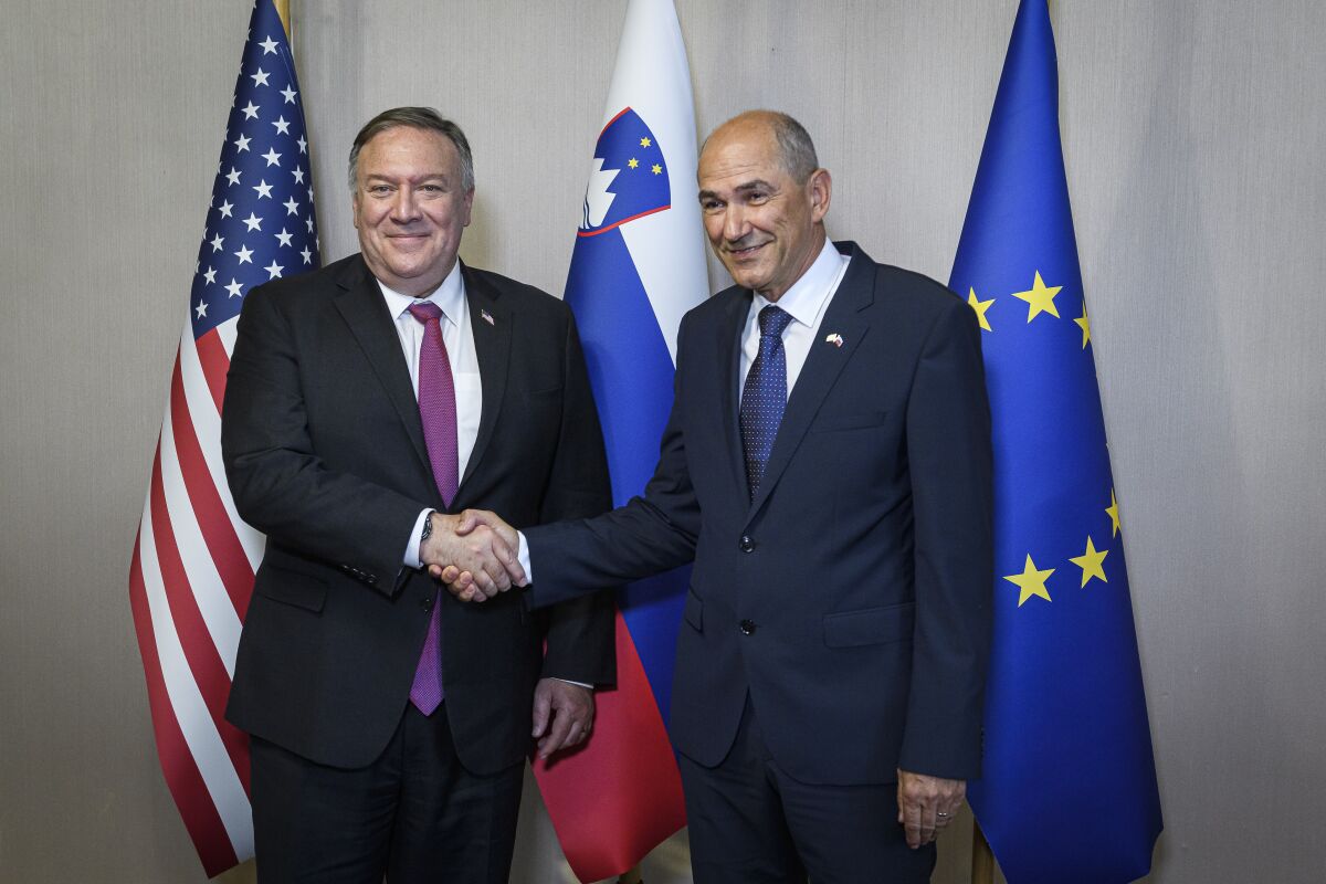 Slovenian Prime Minister Janez Jansa, right, shakes hands with US Secretary of State Mike Pompeo ahead of their meeting in Bled, Slovenia, Thursday, Aug. 13, 2020. Pompeo is on a five-day visit to central Europe with a hefty agenda including China's role in 5G network construction. (Jure Makovec/Pool Photo via AP)