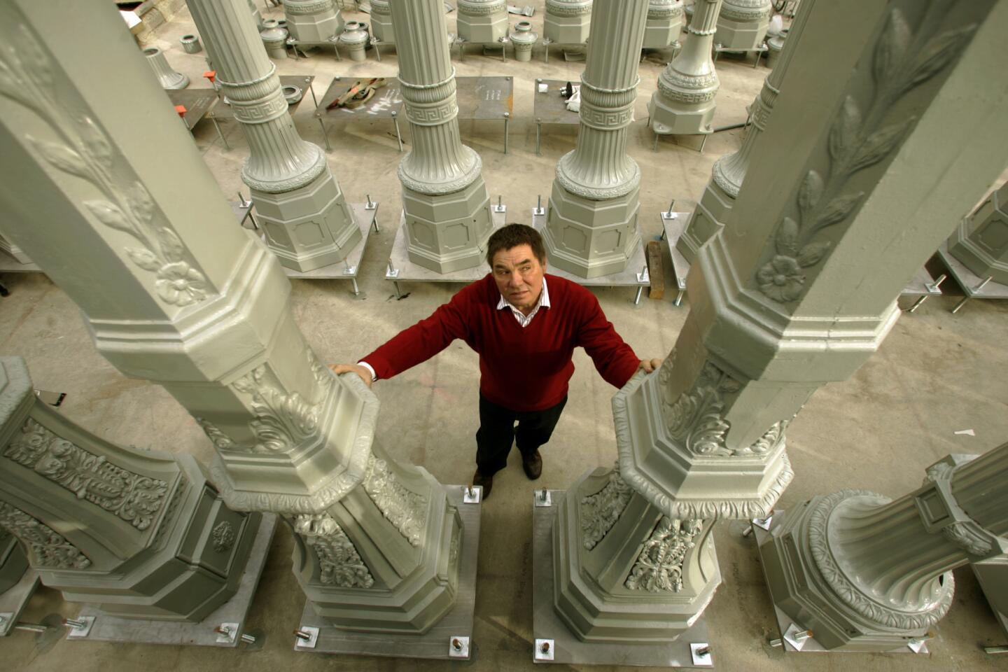 Chris Burden stands in "Urban Light," in front of the entryway to the Los Angeles County Museum of Art.