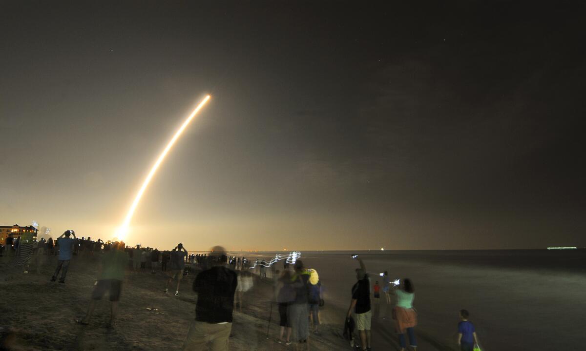 Cellphones light up the beaches of Cape Canaveral and Cocoa Beach, Fla., as spectators watch the launch of the NOAA GOES-R weather satellite on Saturday.