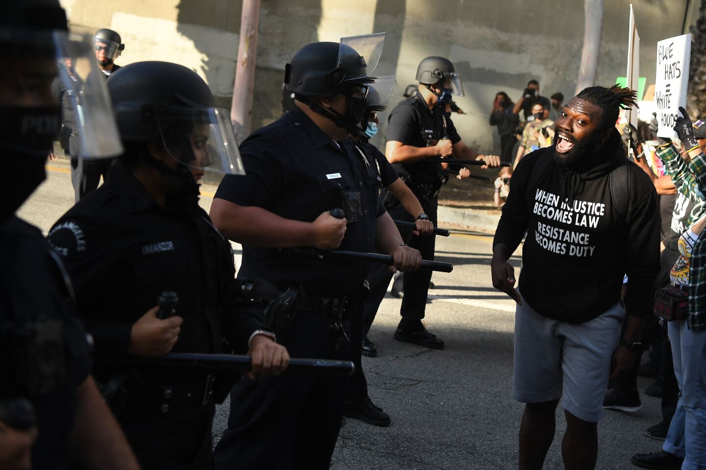 A protester confronts LAPD officers on May 29 in downtown L.A.