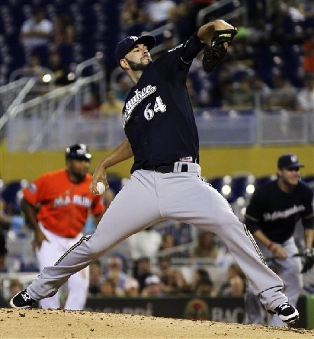 Brewers get winning streak started with extra inning win over Marlins