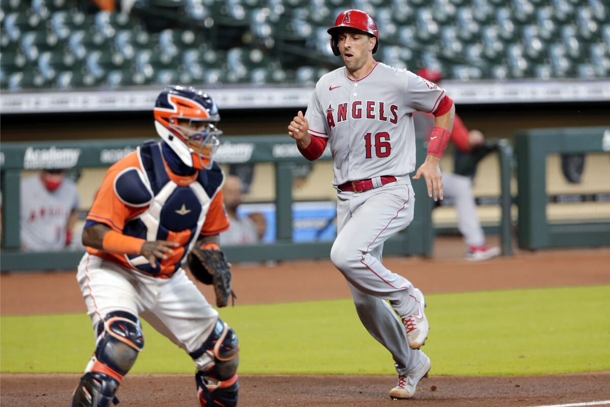 Angels' Jason Castro scores behind Houston Astros catcher Martin Maldonado during a game on Tuesday.