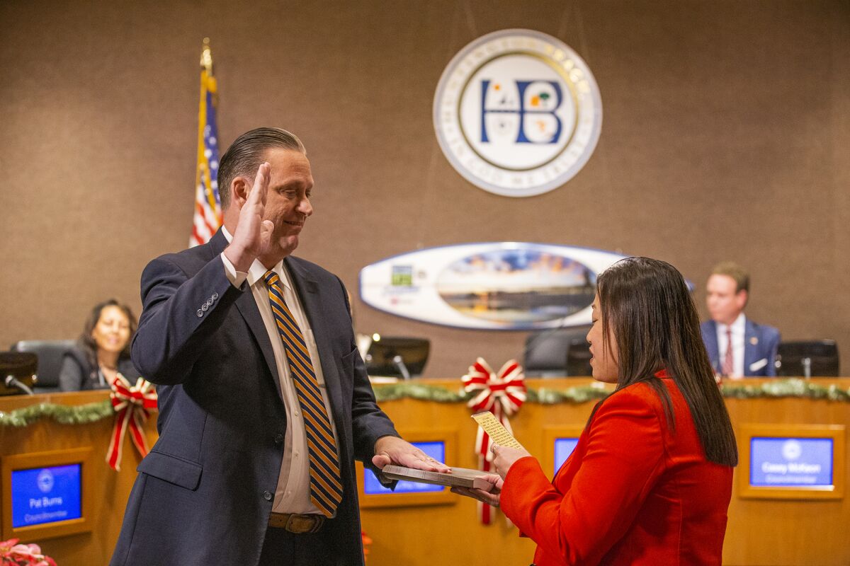 Tony Stickland is sworn in as mayor by state Sen. Janet Nguyen at the Huntington Beach City Council chambers on Tuesday.