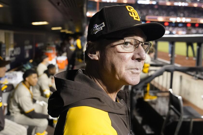 San Diego Padres manager Bob Melvin watches from the dugout before Game 3 of a National League.