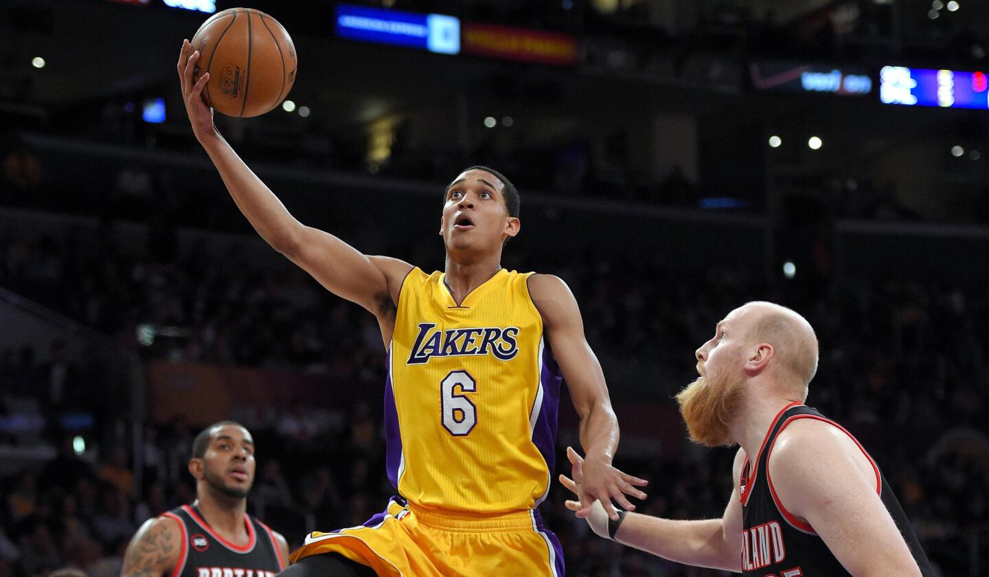 Lakers guard Jordan Clarkson drives down the lane for a layup against Trail Blazers center Chris Kaman in the first half Friday night at Staples Center.