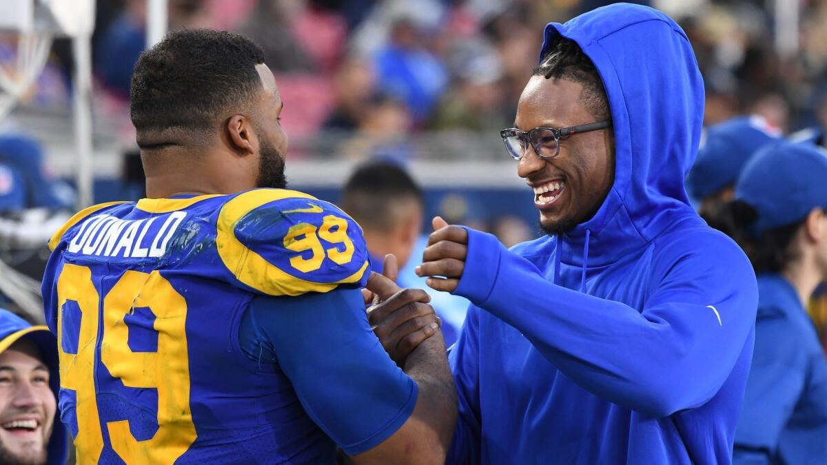 Rams Aaron Donald and Todd Gurley share a laugh near the end of the game against the 49ers at the Coliseum.