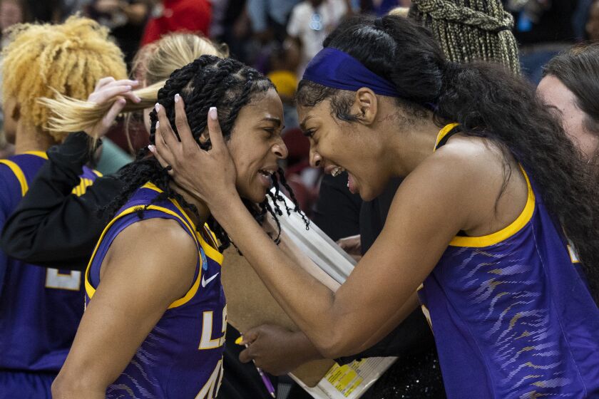 LSU's Angel Reese, at right, hugs teammate Alexis Morris, left, after defeating Utah in a Sweet 16 college basketball game of the NCAA Tournament in Greenville, S.C., Friday, March 24, 2023. (AP Photo/Mic Smith)