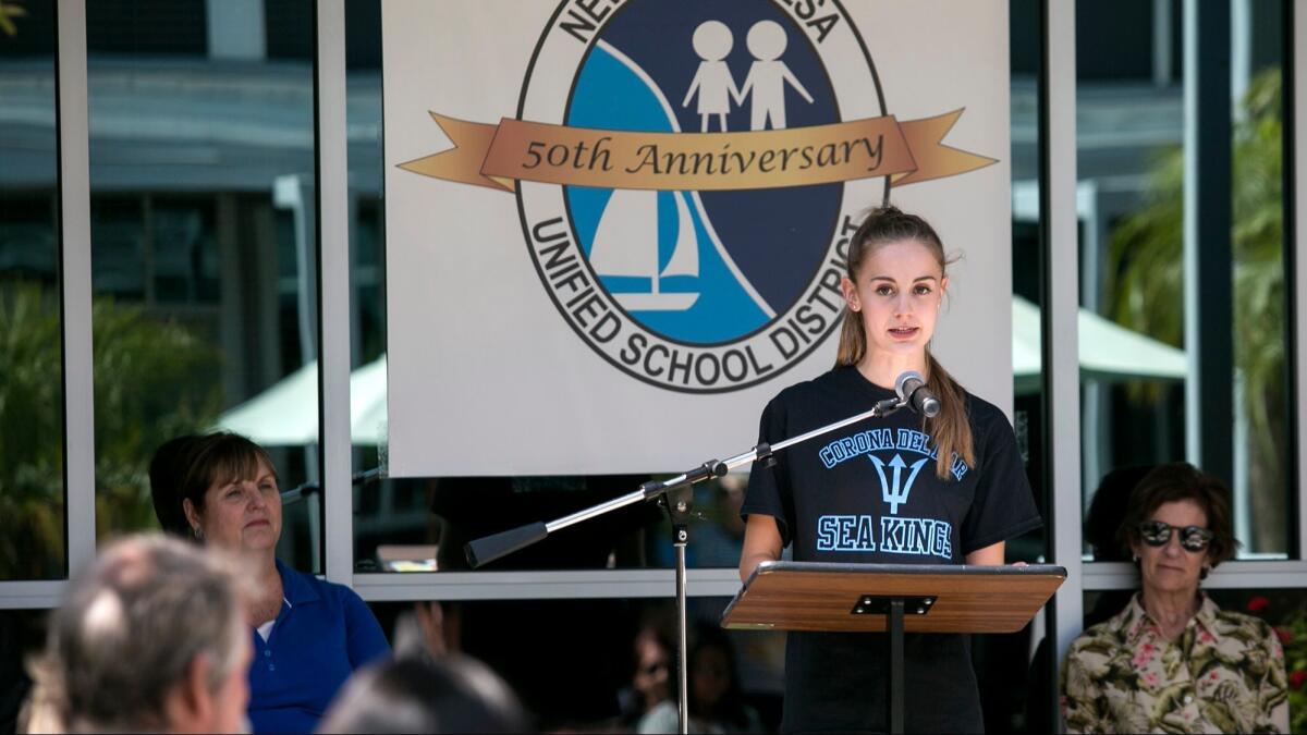 Abigail Peterson, 18, a senior at Corona del Mar High School, reads a letter that will be placed in a time capsule during an event at the Newport-Mesa Unified School District offices on Friday.