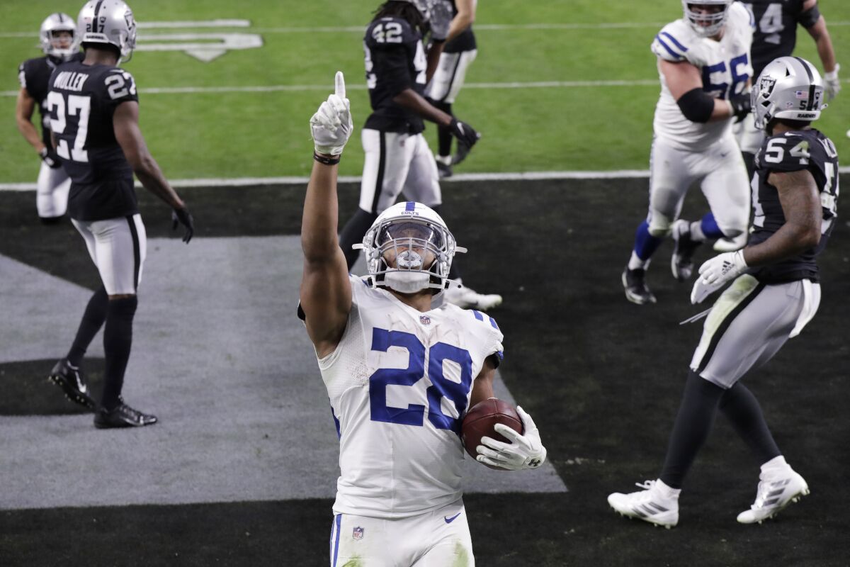 Indianapolis Colts running back Jonathan Taylor (28) celebrates after scoring a touchdown against the Las Vegas Raiders during the second half of an NFL football game, Sunday, Dec. 13, 2020, in Las Vegas. (AP Photo/Isaac Brekken)