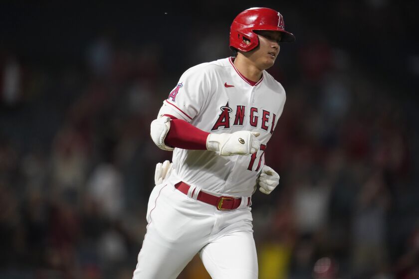 Angels' Shohei Ohtani rounds first base after a solo home run during the 8h inning of a game against the Houston Astros
