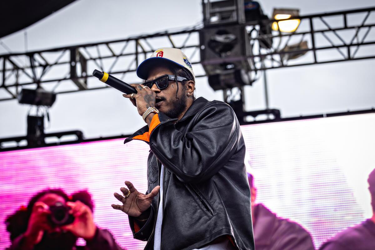 Ab-Soul performs at Top Dawg Entertainment's annual toy drive and concert at the Nickerson Gardens housing projects Tuesday in Los Angeles.