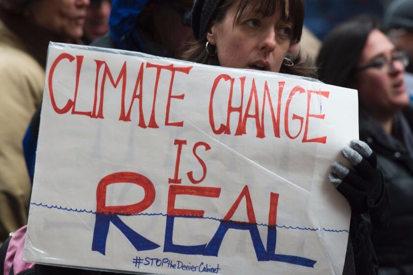 Activists in New York rally to urge politicians to stand against climate change denial.