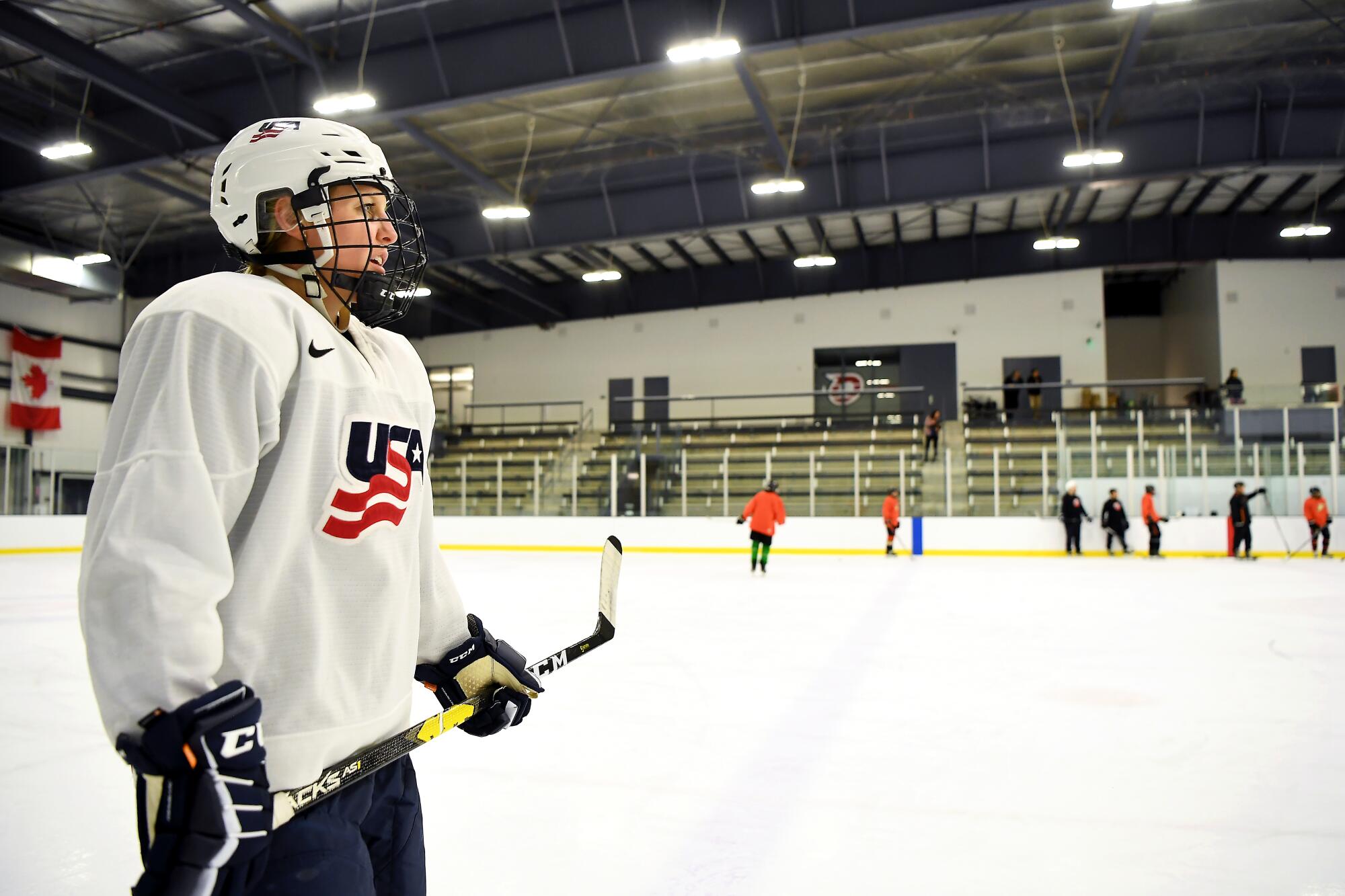 Coyne Schofield's talent and experience, not to mention the big "USA" emblazoned on her white national team jersey, make the Jr. Ducks players wonder why she practices with them.