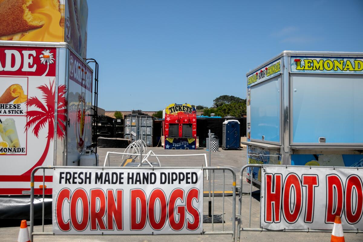 A ticket stand sits behind a handful of vendors that sell fair food on the weekend as the Del Mar Fairgrounds lies empty 