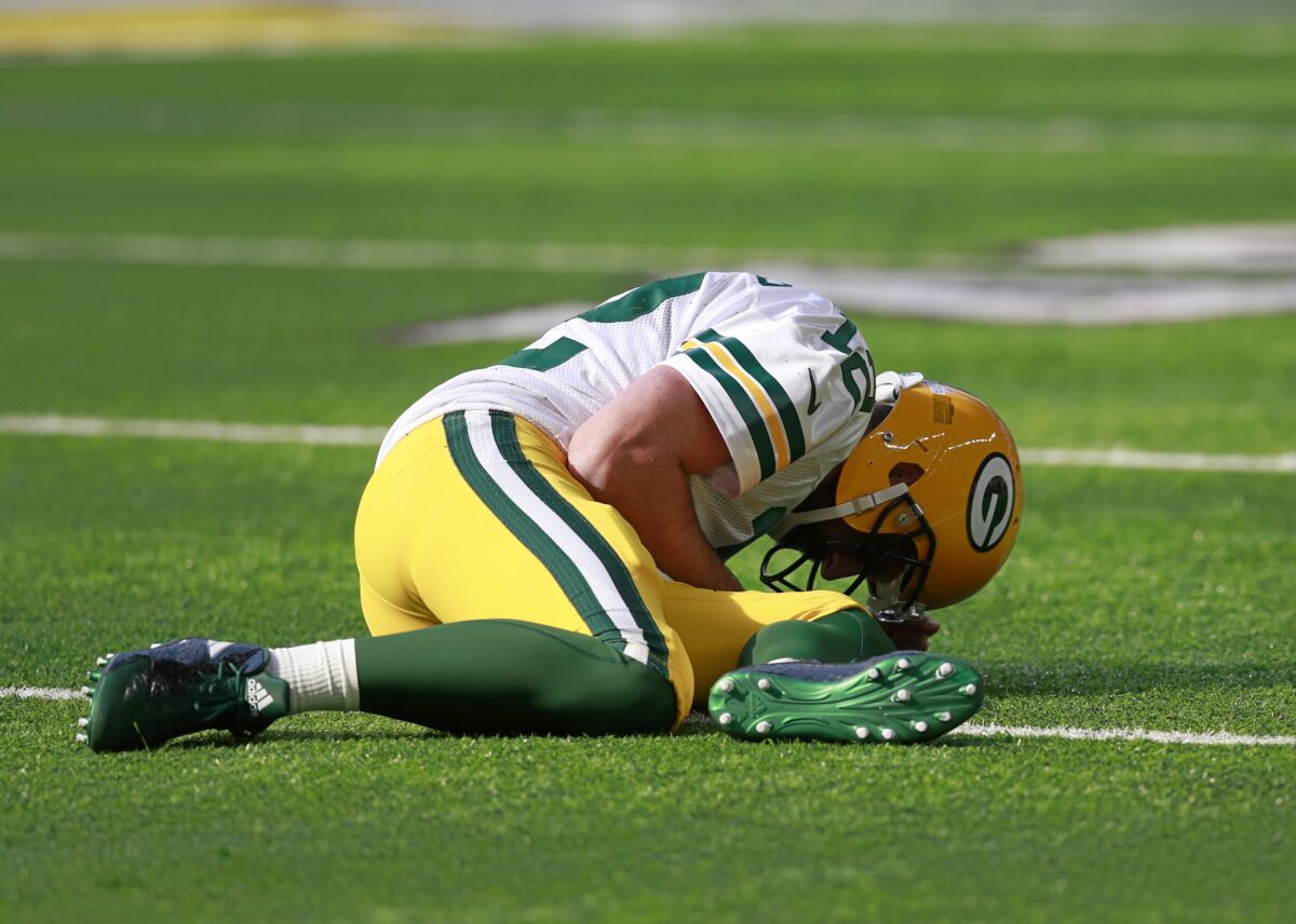 Aaron Rodgers lies on the ground after being hit by Minnesota Vikings outside linebacker Anthony Barr and breaking his collar bone in October 2017.