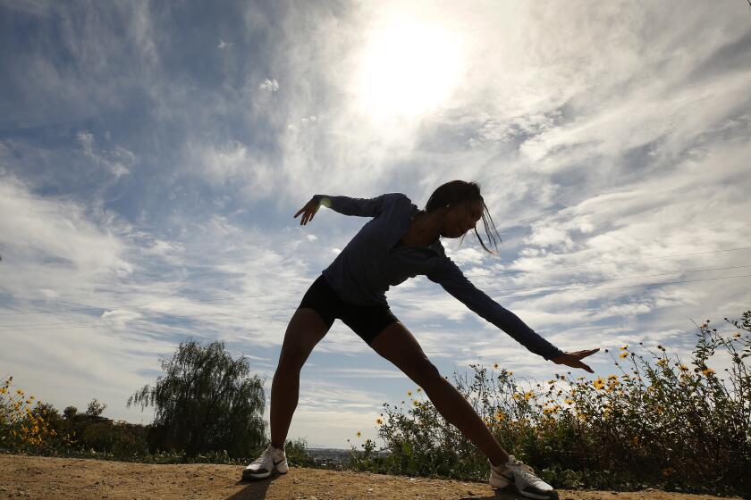 LOS ANGELES, CA - MARCH 09, 2020 Actress and dancer Nayriah Teshali, 26, from Los Angeles completes a dance workout following her climbing workout to the top of the Baldwin Hills Scenic Overlook State Park on Monday afternoon as clouds being too move in before a moisture-rich atmospheric river approaches the coast of Southern California and is expected to unleash the first significant rainfall of the year beginning late Monday. "I always like to dance at the top to end my workout." Nayriah exclaimed. (Al Seib / Los Angeles Times)