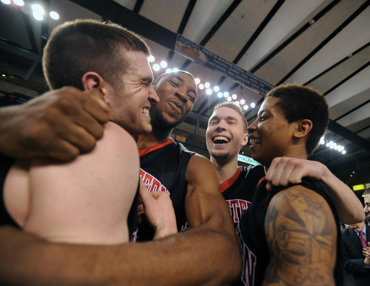 Northeastern players, left to right, Caleb Donnelly, Kwesi Abakah, Jimmy Marshall and T.J. Williams celebrate their upset victory over William and Mary in the Colonial Athletic Association conference tournament.