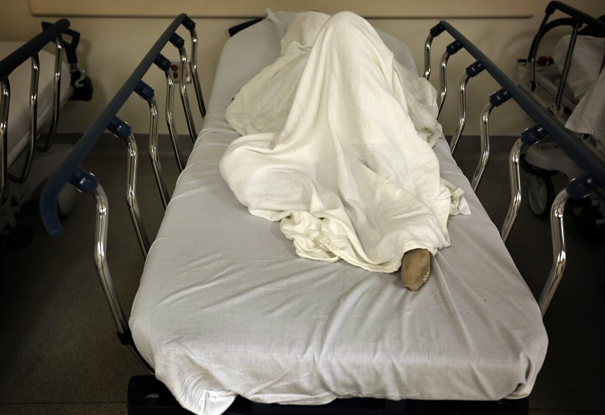 A recent county report found that more acute psychiatric beds are needed to stem the increase in mentally ill defendants landing in court. Above, a patient in the emergency psychiatric unit at County-USC Medical Center in 2015.